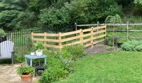 unpainted rail fence in progress of being built